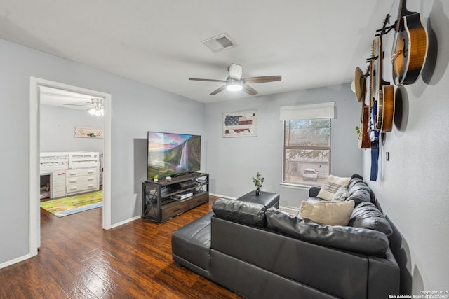 living room featuring ceiling fan and dark hardwood / wood-style flooring