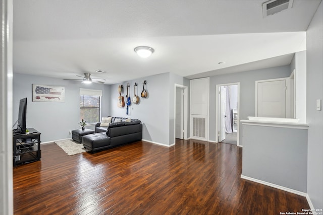 living room with ceiling fan and dark hardwood / wood-style flooring