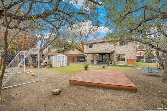 exterior space featuring a wooden deck and a storage shed