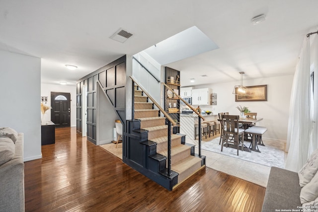 staircase with hardwood / wood-style flooring