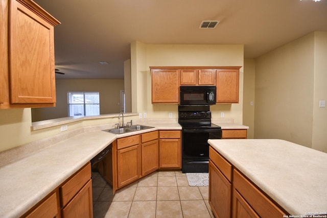 kitchen featuring light tile patterned floors, kitchen peninsula, ceiling fan, black appliances, and sink