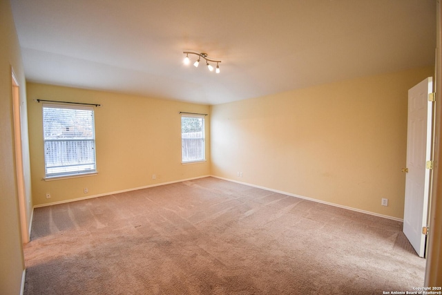 carpeted spare room featuring a healthy amount of sunlight