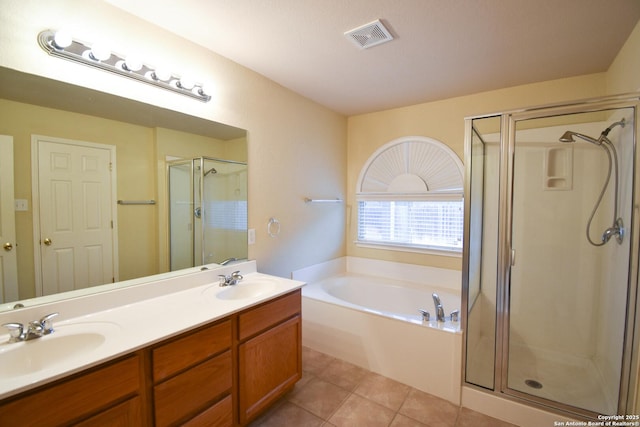 bathroom featuring vanity, tile patterned flooring, and plus walk in shower