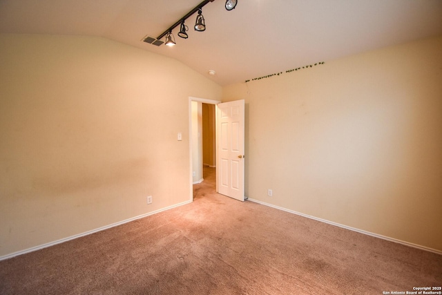 empty room with light carpet and lofted ceiling