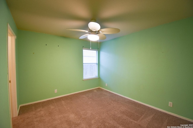 spare room with carpet floors and ceiling fan