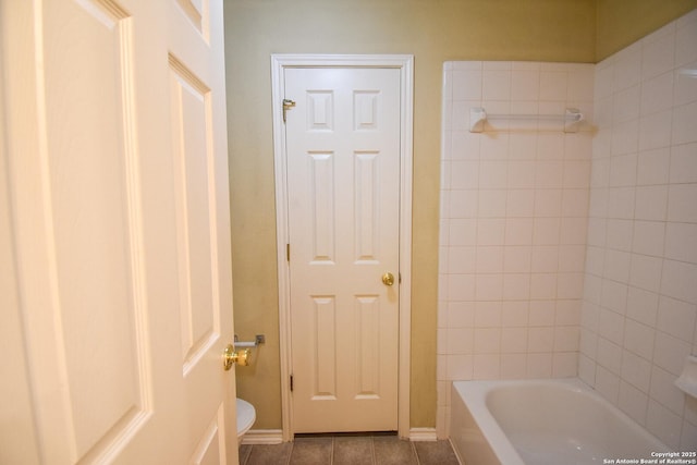 bathroom with toilet and tile patterned floors