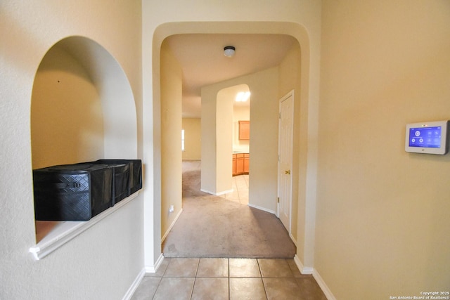 corridor featuring light tile patterned flooring