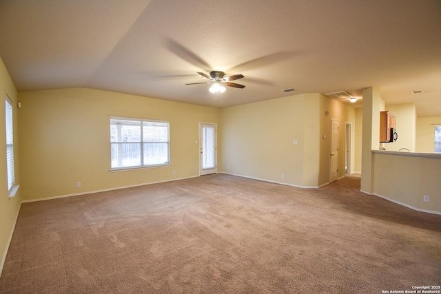 spare room featuring ceiling fan, carpet floors, and lofted ceiling