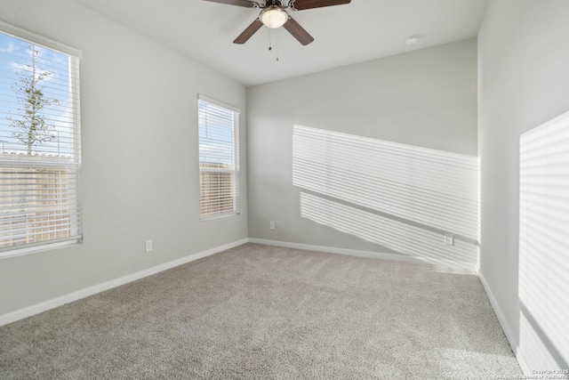 carpeted spare room featuring ceiling fan