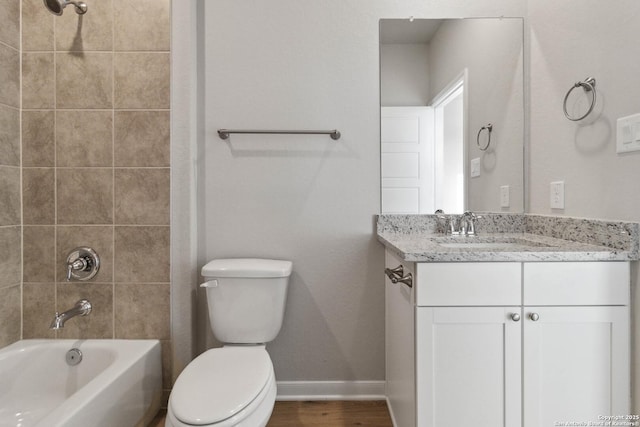 full bathroom featuring toilet, vanity, and tiled shower / bath