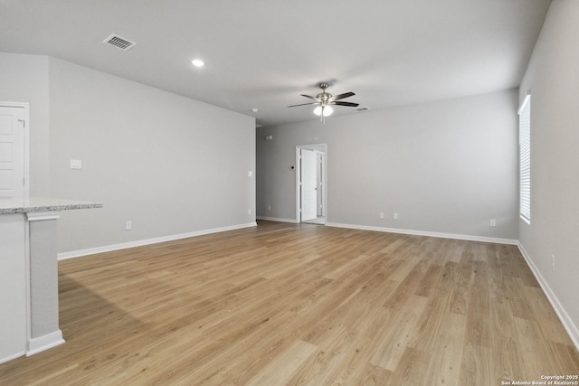 unfurnished room featuring light hardwood / wood-style floors, plenty of natural light, and ceiling fan