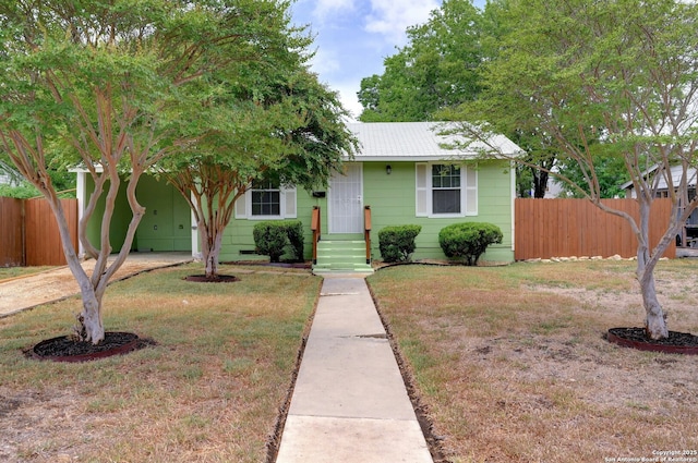 view of front facade with a carport and a front yard