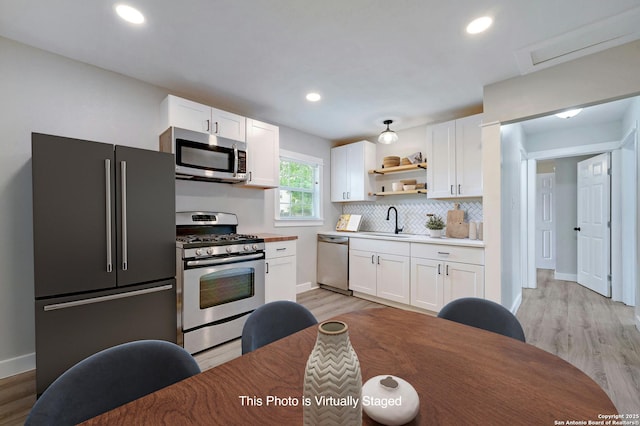 kitchen featuring white cabinets, appliances with stainless steel finishes, and sink