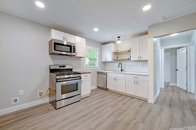 kitchen with white cabinets, sink, and stainless steel appliances