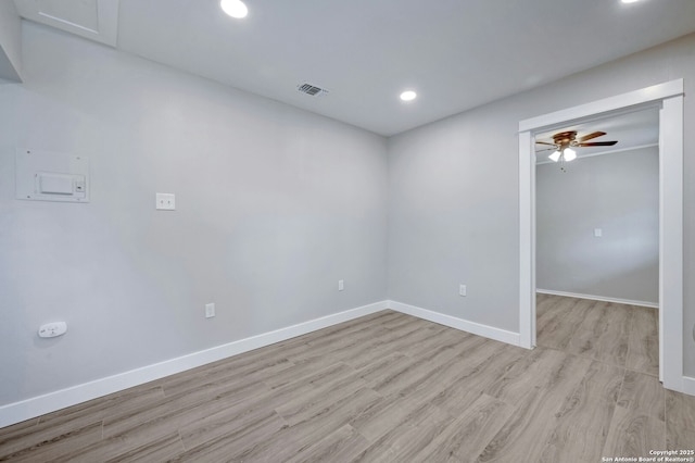 empty room featuring ceiling fan and light hardwood / wood-style flooring