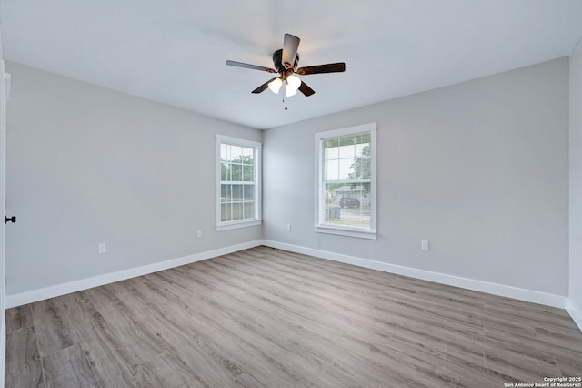 empty room with ceiling fan and light hardwood / wood-style flooring