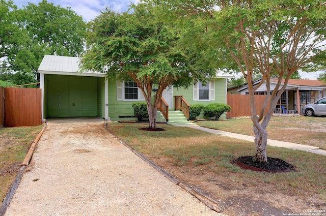 view of front facade with a carport and a front yard