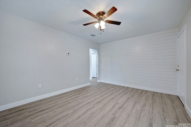 spare room featuring ceiling fan and light hardwood / wood-style floors