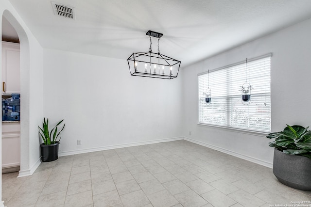 tiled dining space with a notable chandelier