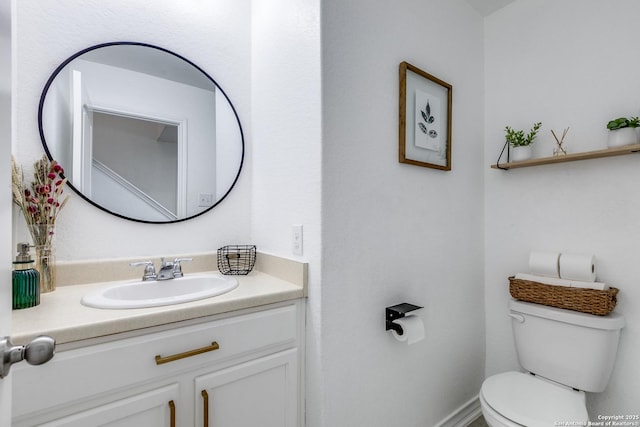 bathroom featuring toilet and vanity