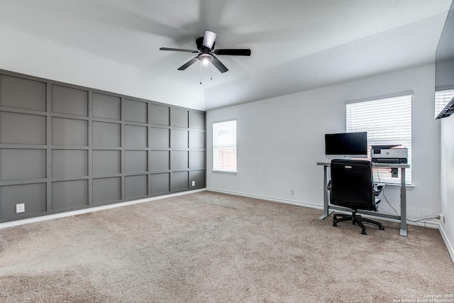 unfurnished office featuring ceiling fan, light colored carpet, and vaulted ceiling