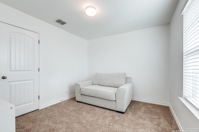 living area with light colored carpet