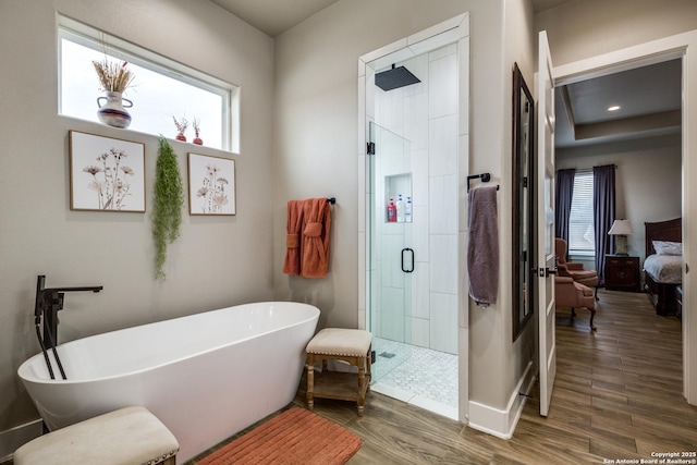 bathroom with separate shower and tub, a wealth of natural light, and wood-type flooring