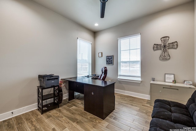 office with ceiling fan and light hardwood / wood-style floors