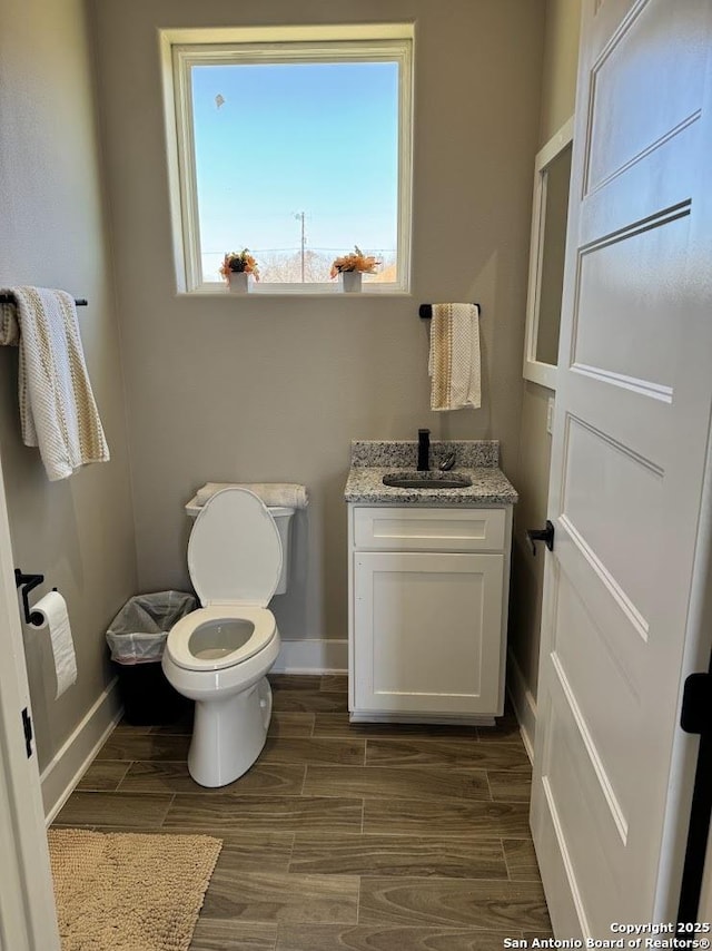 bathroom featuring toilet and vanity