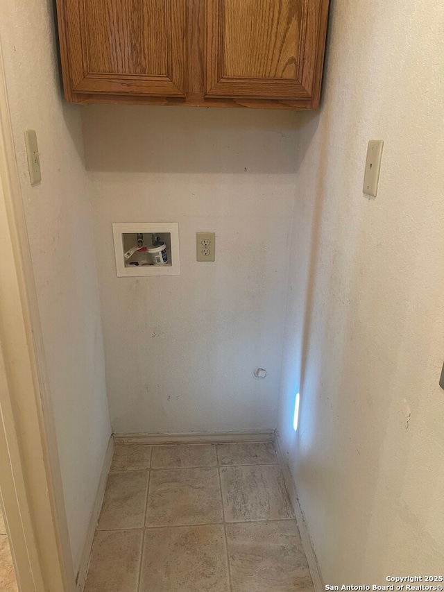 laundry room featuring hookup for a washing machine and cabinets