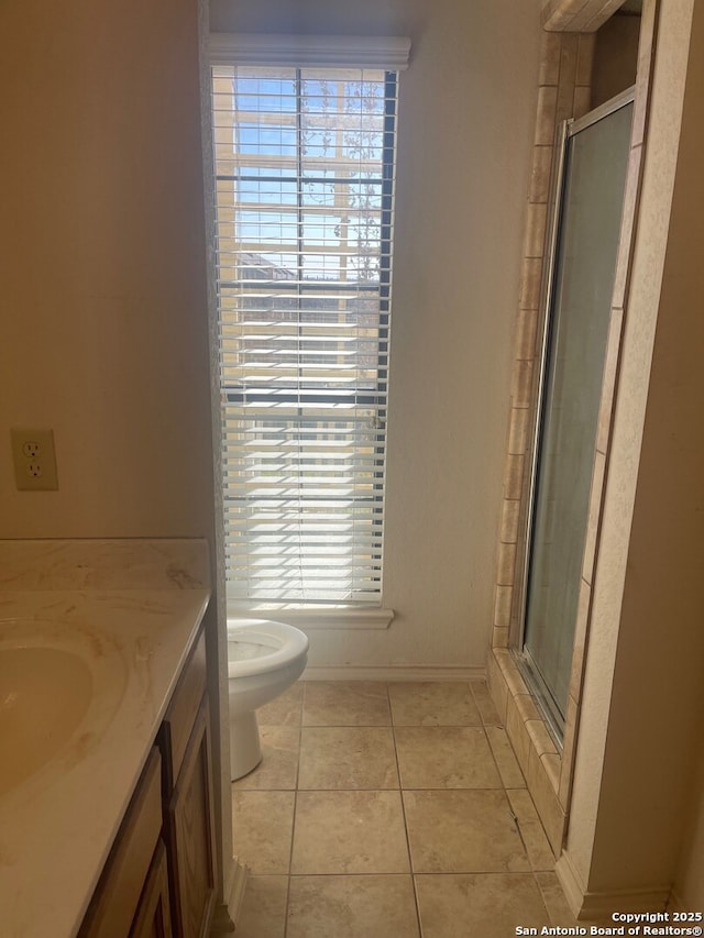 bathroom featuring an enclosed shower, vanity, toilet, and tile patterned flooring