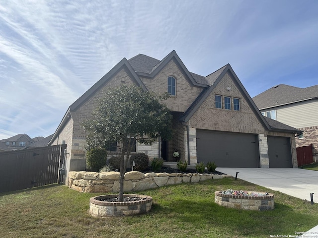 view of front of house featuring a garage and a front lawn