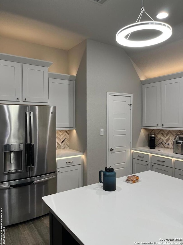 kitchen with hanging light fixtures, backsplash, dark hardwood / wood-style flooring, and stainless steel fridge with ice dispenser