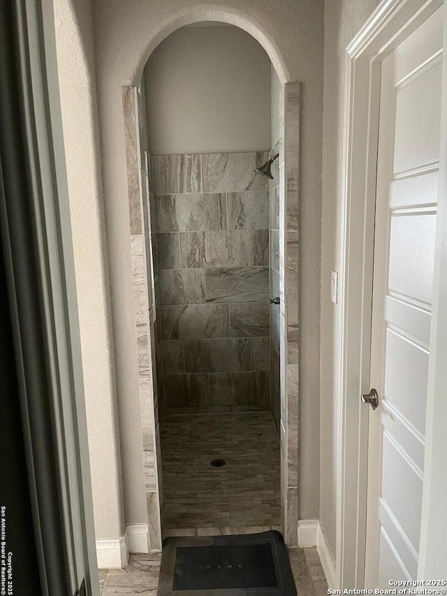 bathroom with a tile shower