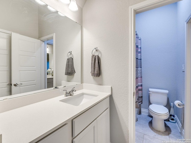 bathroom featuring a shower with curtain, vanity, tile patterned floors, and toilet