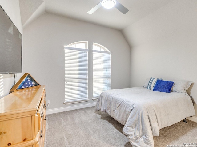 carpeted bedroom featuring lofted ceiling and ceiling fan