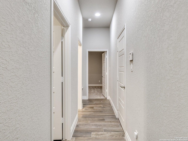 hallway with light hardwood / wood-style flooring