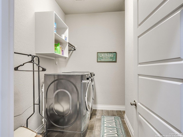 washroom with washing machine and clothes dryer