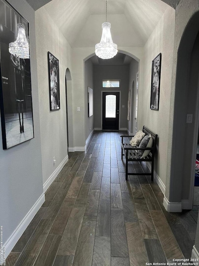 entrance foyer with lofted ceiling and a notable chandelier