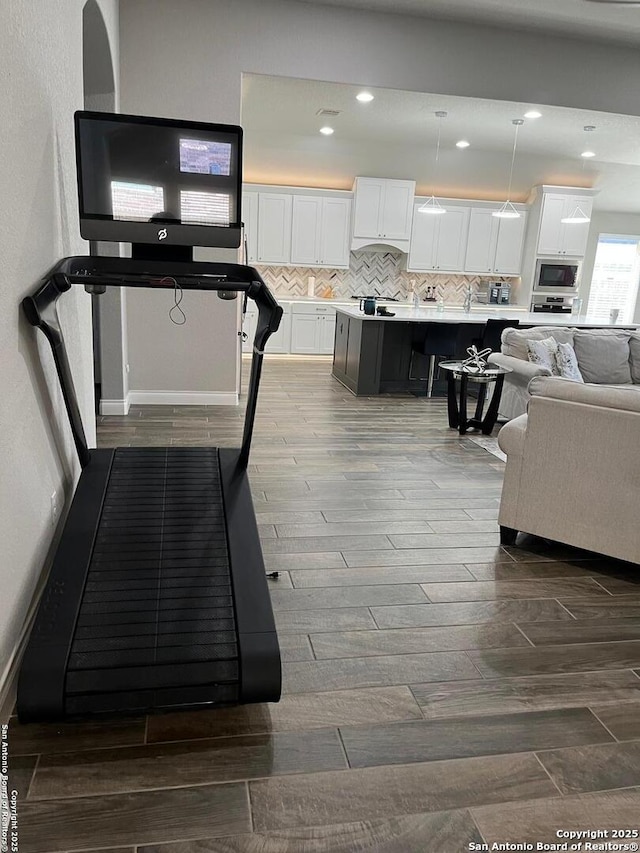 workout area with hardwood / wood-style floors