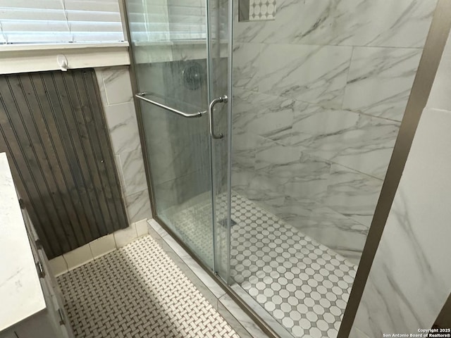 bathroom with tile patterned flooring and walk in shower