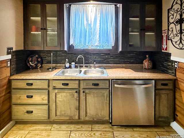 kitchen with decorative backsplash, sink, and dishwasher