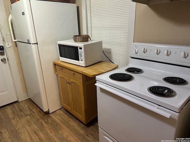 kitchen featuring dark hardwood / wood-style flooring and white appliances