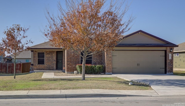 view of front of house featuring a garage and a front lawn