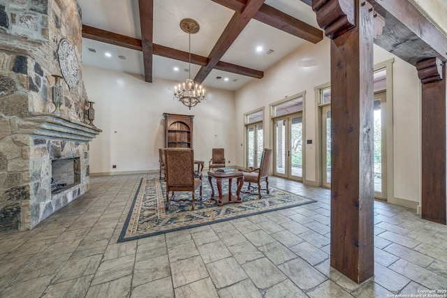 dining space with beam ceiling, a notable chandelier, and a fireplace