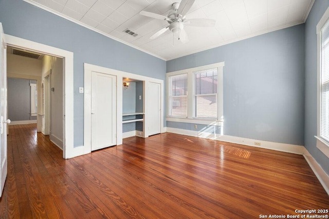 empty room with hardwood / wood-style flooring, ornamental molding, and ceiling fan