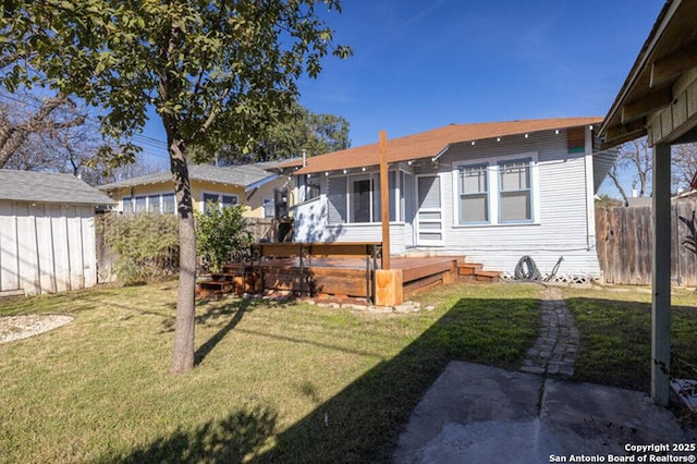 view of front of home featuring a front yard and a deck