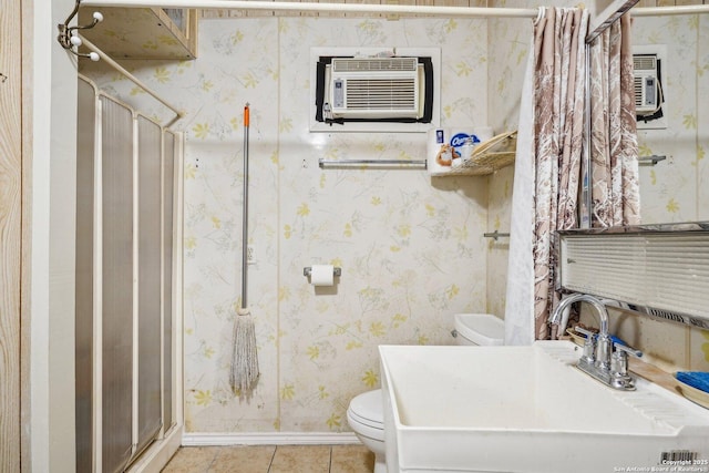 bathroom with toilet, a wall mounted AC, tile patterned flooring, walk in shower, and sink