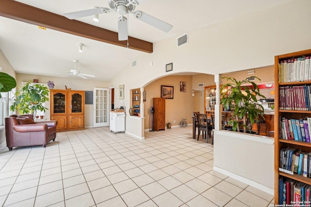 tiled living room featuring ceiling fan and vaulted ceiling with beams