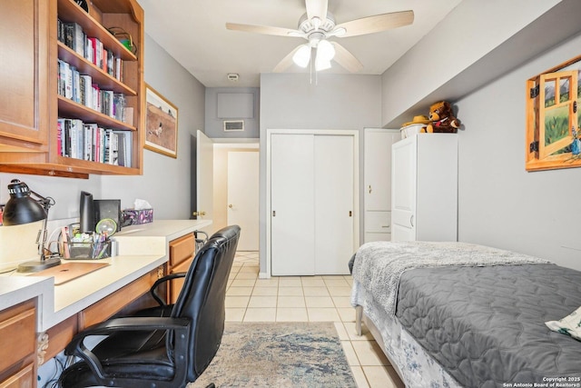 bedroom featuring ceiling fan, a closet, and light tile patterned flooring